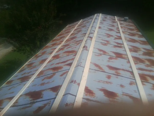 Rusted metal roof panels with new wood purlins before replacement — Storm Damage Roof Repair in Smelterville by Roofing Brothers