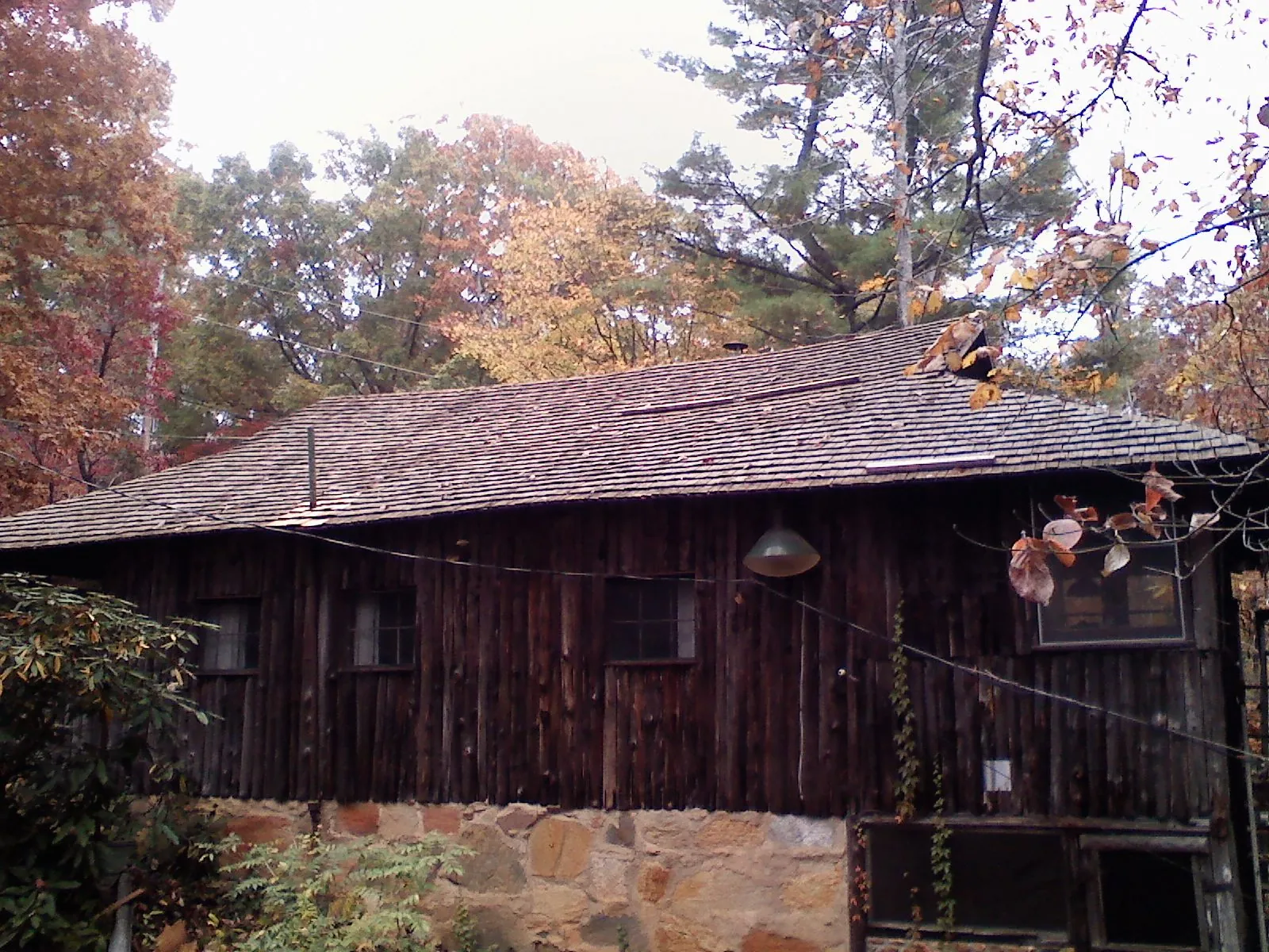Weathered wood shake roof on a rustic board sided cabin in Smelterville